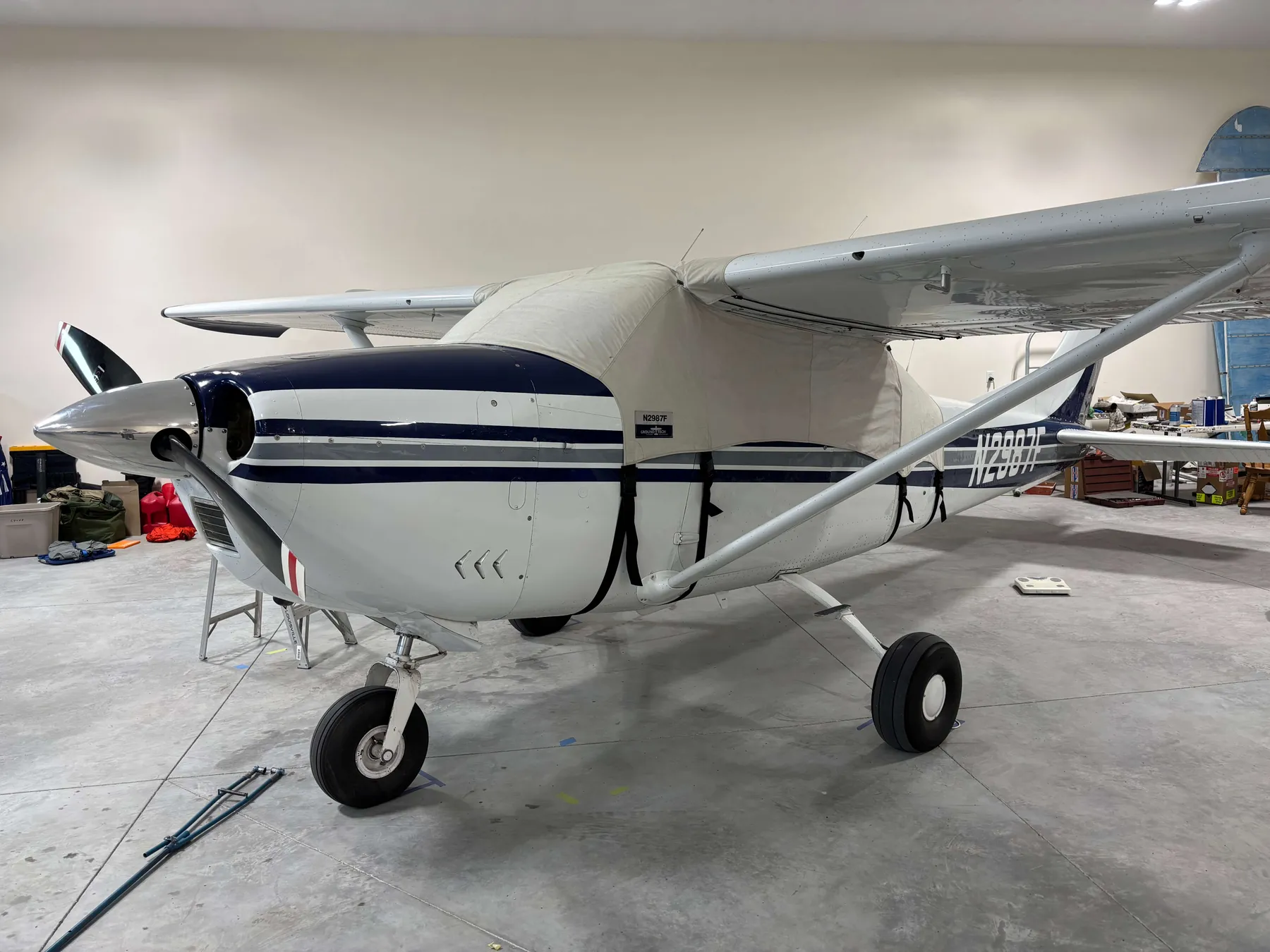 N2987F inside its hangar with the fitted airplane cover installed